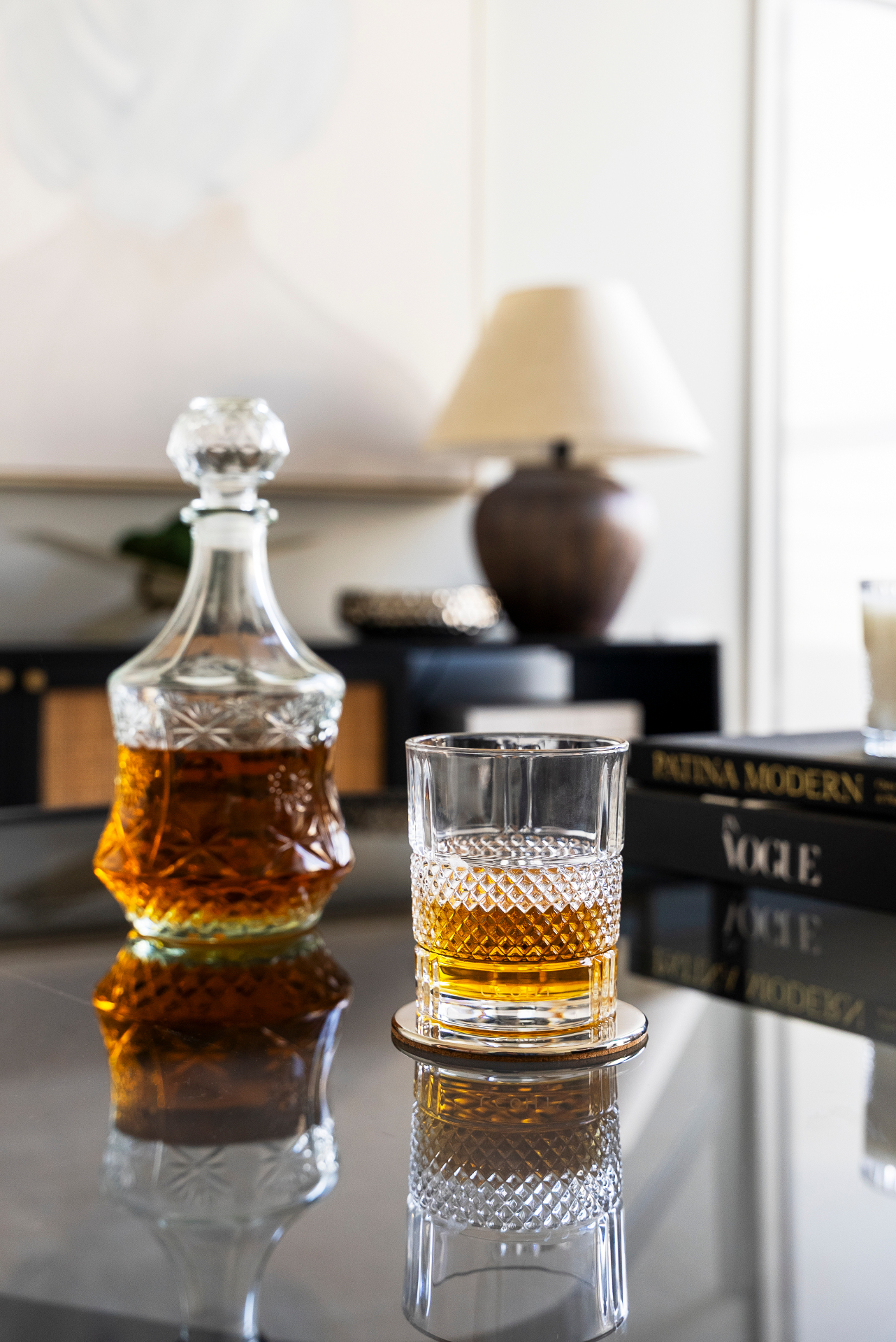 The Lēoht vessel reused as a whiskey glass on a bamboo side table