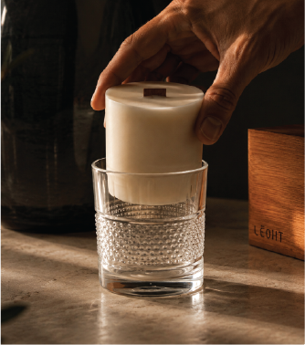 Placing a Lēoht wax refill into the diamond-cut vessel