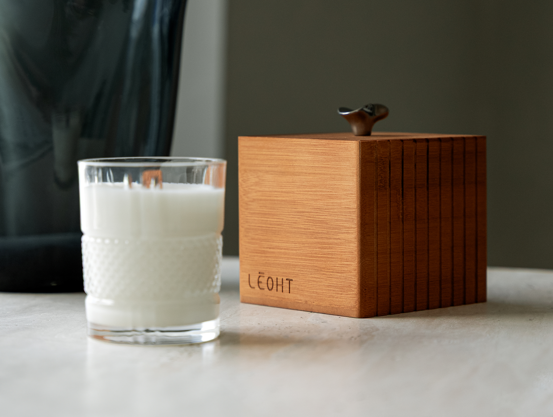 Amberwood Harmony — The Moment candle beside the bamboo gift box
